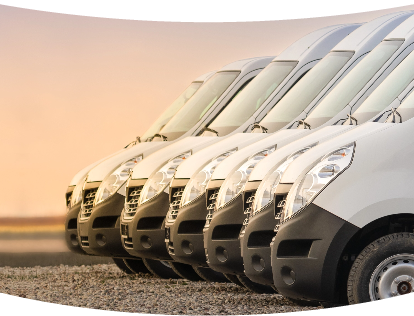 Row of white trucks parked side by side